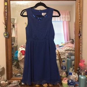A kids blue sleeveless flowy dress